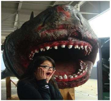 A portrait of the author in front of a fake shark.