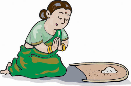 A Vinoba's mother on her knees praying as she makes her offering of rice.