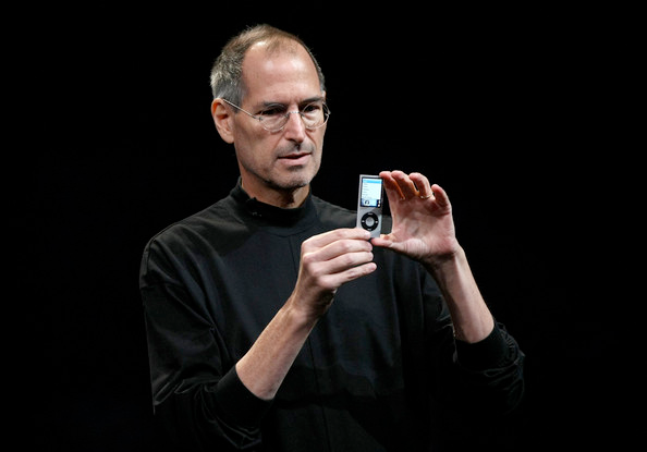Steve Jobs holding an iPod
