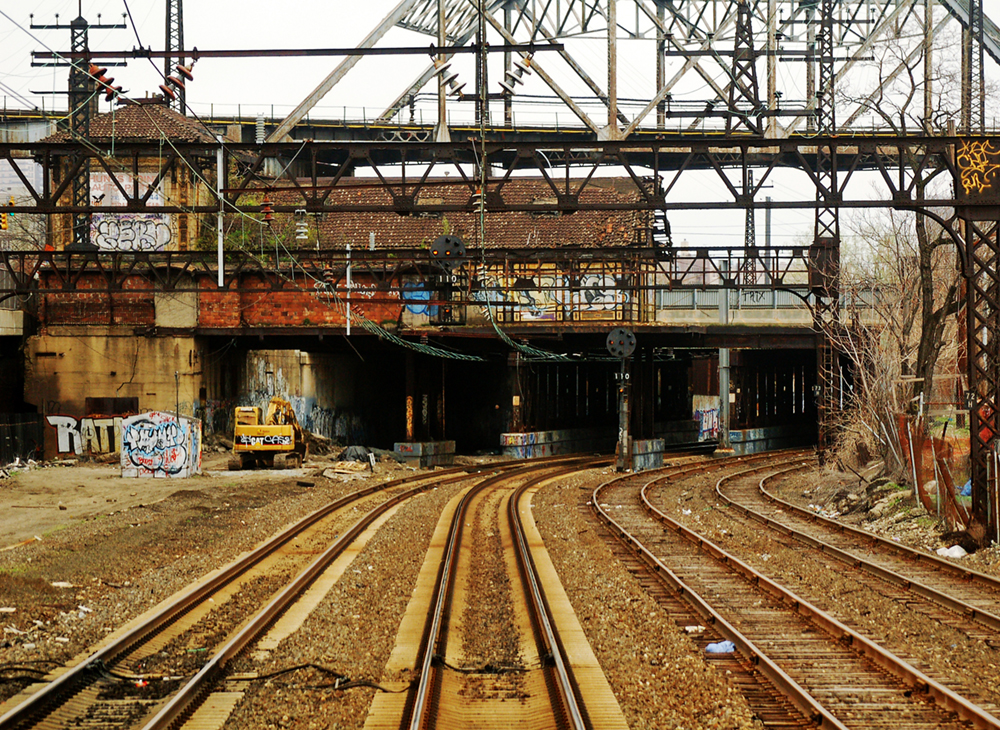 Run-down train tracks and railroad bridges are shown here.