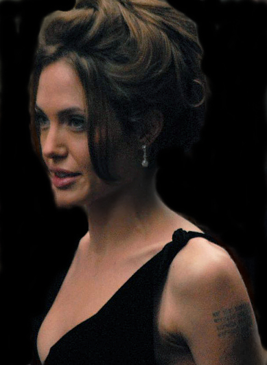 A woman with brown hair and a tattoo is shown here.
